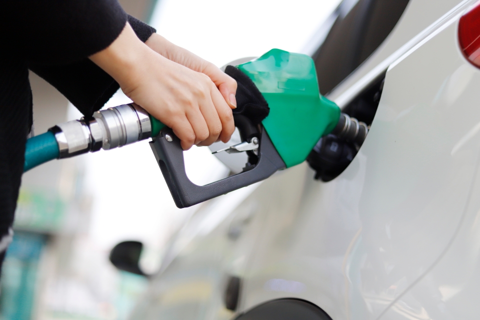 Person filling up car with petrol